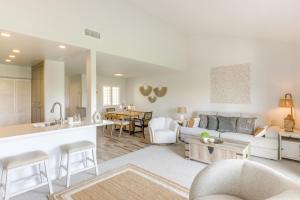 a living room and kitchen with a couch and a table at Steps to Indian Wells Condo with Golf Course Views! in La Quinta
