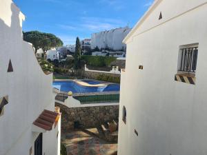 an overhead view of a swimming pool between two buildings at Rosap in Roses