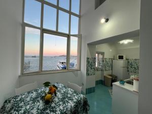 a room with a bed and a view of the water at Casa MiraMare in Procida