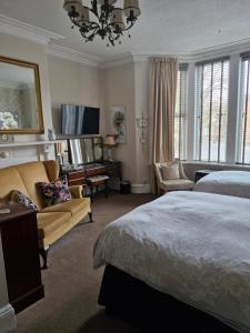 a bedroom with a bed and a living room at Warwick Lodge in Carlisle