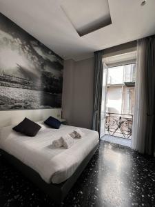 a bedroom with a bed with towels on it at Beverello Rooms in Naples