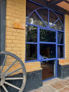 a window with a wooden wheel in front of it at Los Cruxes in Tepoztlán