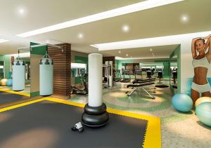 a room with a gym with a woman on the wall at Apartamento Resort Solar das Águas em Olímpia in Olímpia