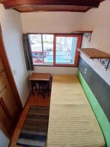 ein kleines Zimmer mit einem Bett und einem Fenster in der Unterkunft Tipo chalé na Lapa in Rio de Janeiro + 15 Fotos