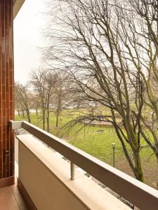 a balcony with a view of a field and trees at Honey Exclusive Apartment - Train Station - Near Center in Milan