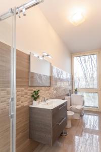 a bathroom with a sink and a toilet and a mirror at Honey Exclusive Apartment - Train Station - Near Center in Milan