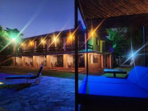 a house with a bench in the yard at night at Los Cruxes in Tepoztlán