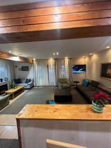 a living room with a couch and a table at Vila Valentina in Buşteni