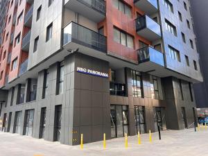 a large building with a nico random sign on it at NBG d 'amore Appart in Batumi