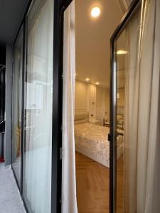 a bedroom with a bed and a sliding glass door at NBG d 'amore Appart in Batumi +41 photos