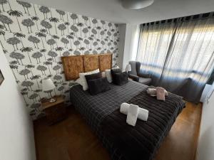 - une chambre avec un lit et une couette noire dans l'établissement El Rincón del Reloj, à Llanes