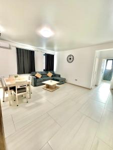 a living room with a couch and a table at B2 Boutique Apartments in Năvodari