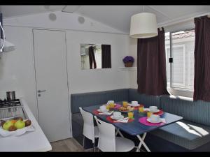 a kitchen with a blue table with chairs and a tableablish at Camping Kato Alissos in Káto Alissós