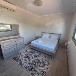 a bedroom with a bed and a tv and a rug at Casa Serenity Villa Taghazout Bay Tamda in Taghazout +42 photos