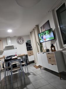 a living room with a tv on a wall at Maison entière paisible in Tarbes