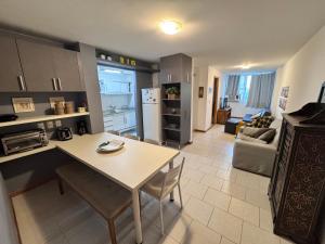 a kitchen and living room with a table and chairs at Lapa reformado melhor localização in Rio de Janeiro