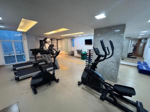 a gym with treadmills and ellipticals in a room at Lapa reformado melhor localização in Rio de Janeiro