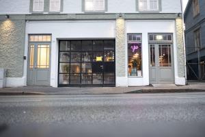 a store front with large windows on a city street at Nygårdsgaten apartments in Bergen