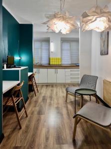 a kitchen with a table and chairs in a room at Апартаменти в центрі старого Львова in Lviv