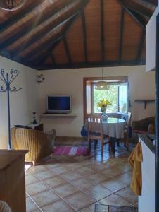 a living room with a table and a tv at Casa Mosaico, sunset and garden in Los Llanos de Aridane