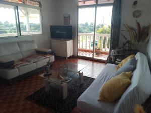 a living room with a couch and a coffee table at La SAISONNIERE RELAIS in Le Gosier