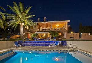a villa with a swimming pool at night at Villa Tranquilla in Estepona