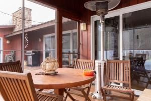 a wooden table and chairs on a patio at Charming home - views of Hunter Mountain slopes in Hunter
