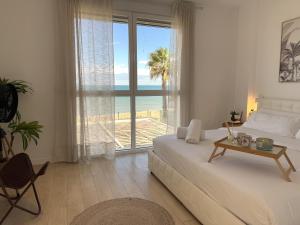 a bedroom with a bed and a view of the ocean at Casa Del Mar, piscina privada frente al mar in Cullera +54 photos