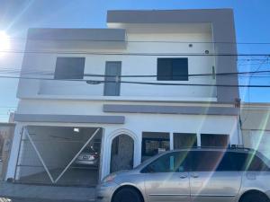 a car parked in front of a building at Apartamentos Residencias in Mexicali