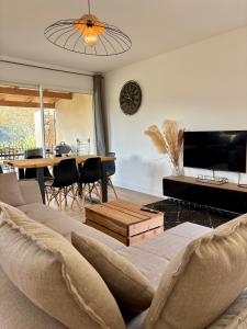 a living room with a couch and a table at Villa de Montchamp in Chambonas