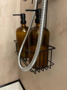 two bottles of soap in a holder on a wall at Cocon du Berry cœur historique in Bourges +4 photos