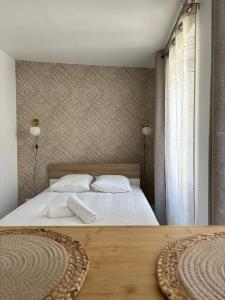 a bedroom with a bed with two white pillows at Cocon du Berry cœur historique in Bourges