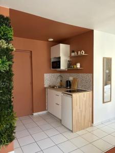 a kitchen with a sink and a counter top at Cocon du Berry cœur historique in Bourges