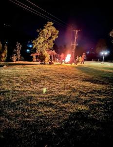 a park at night with a fire in the grass at Wooden Attic cottage in Pori