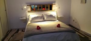 a bedroom with a bed with red shoes on it at Do Mar in Bisceglie