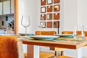 a table with wine glasses and plates on it at 3 Zimmer, Beamer, Balkon, Disney Plus in Woltersdorf +12 photos