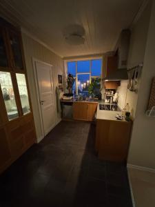 a kitchen with a large window and a view of the city at ONS Apartment in Stavanger