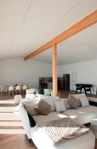 a living room with a white couch and tables at Hohenzollern Wellness Loft mit Panorama Sauna in Burladingen