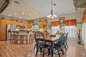 a kitchen with a wooden table and chairs and a dining room at Casa Playa - Ocean Views Pet Friendly Boardwalk in Port Aransas