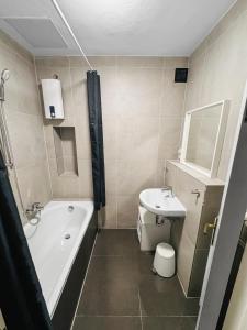 a bathroom with a bath tub and a sink at Zentrale Wohnung in Koblenz