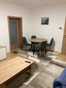 a living room with a table and chairs at Apartman Liezen in Liezen