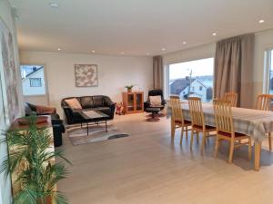 a living room with a table and chairs at apartment With fantastic view and parking in Tromsø