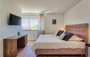 a bedroom with a bed and a tv on the wall at Cld688, Villa Vlahov I in Šibenik