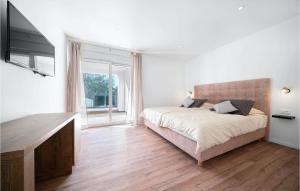 a bedroom with a bed and a large window at Villa Vlahov Ii in Šibenik