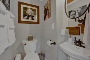 a bathroom with a toilet and a sink and a mirror at Villa D' Citta in Chicago