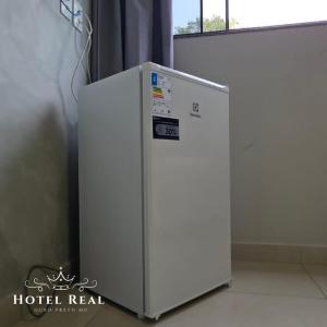 a white refrigerator in a room with a window at Hotel Real in Ouro Preto