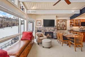a living room with a couch and a fireplace at Shadow Mountain Unit 15, Spacious Ski-In, Ski-Out Townhouse with Great Views & Gas Fireplace in Aspen