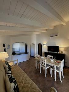 a living room with a table and a couch at Corte dei Mori 239 in Liscia di Vacca