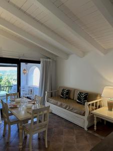 a living room with a couch and a table at Corte dei Mori 239 in Liscia di Vacca