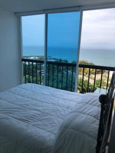 a bedroom with a bed and a view of the ocean at Punta Centinela in Punta Blanca